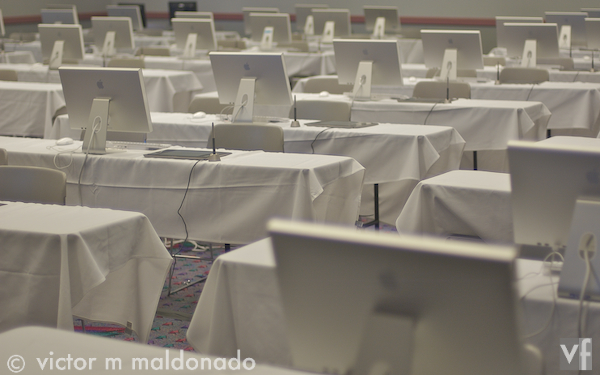 White room with white Apple computers